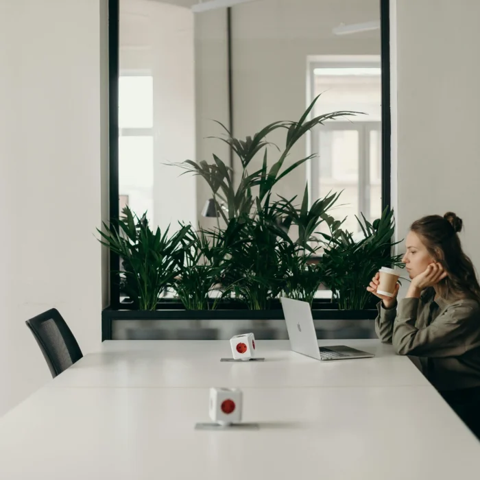 Designer building a modern WordPress website layout on a laptop with responsive previews